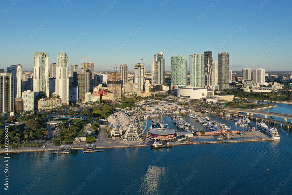 Miami, Florida - December 27, 2020 - Aerial view of Bayside Marketplace, City of Miami Marina and Miami skyline on sunny winter morning.