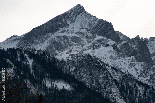 Snow-capped Alpspitze mountain in the European Alps seen from Garmisch-Partenkirchen in Bavaria, Germany, on a dark winter day photo