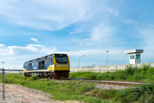 diesel engine train head run on railway track with cloudy and blue sky