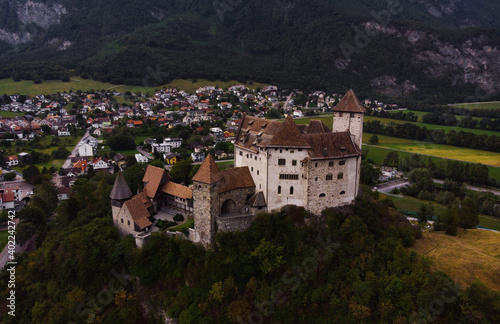 Aerial panoramic view of Burg Gutenberg medieval castle on a hilltop in Balzers Liechtenstein alps mountains