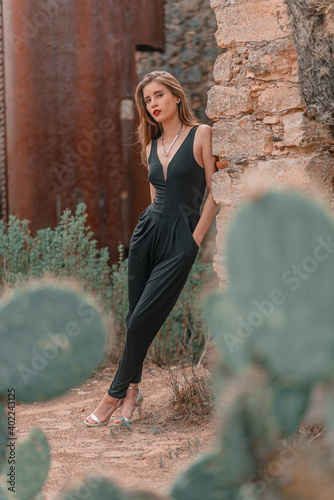 beautiful young woman whit a black jumpsuit in vintage place