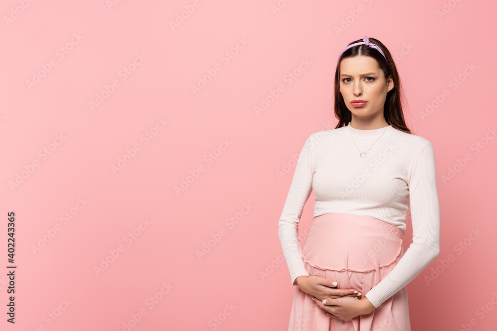 young pretty pregnant woman touching belly isolated on pink young pretty pregnant woman touching belly isolated on pink