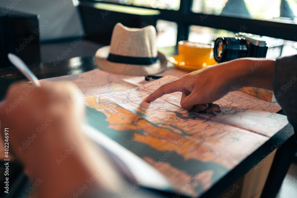 Obraz premium Close-up Tourist planning vacation with map and other travel accessories on the table. Travel, holiday, vocation concept.