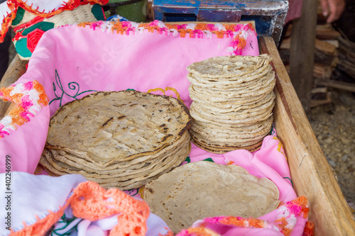 A stack of traditionally cooked tortilla doughts in a wooden box photo