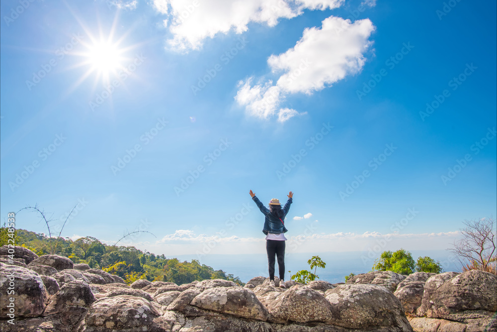Happy female tourists On the high cliff at the bright sun Happy female tourists On the high cliff at the bright sun