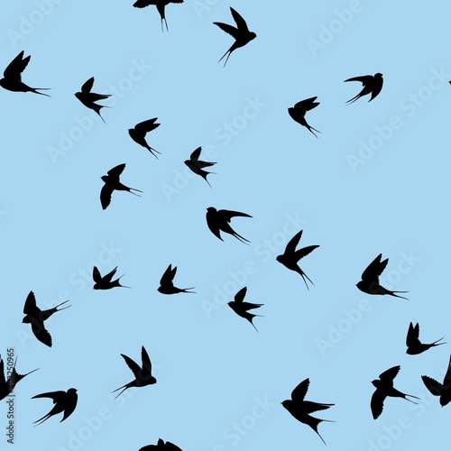 Swallows seamless pattern. Black silhouettes of birds on a blue background. © OlgaShashok