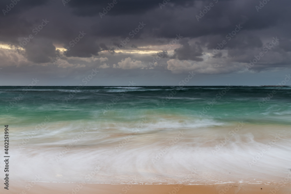 Moody morning bay seascape with rain clouds