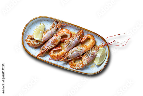 grilled prawns served with lemon on a white background - selective focus.