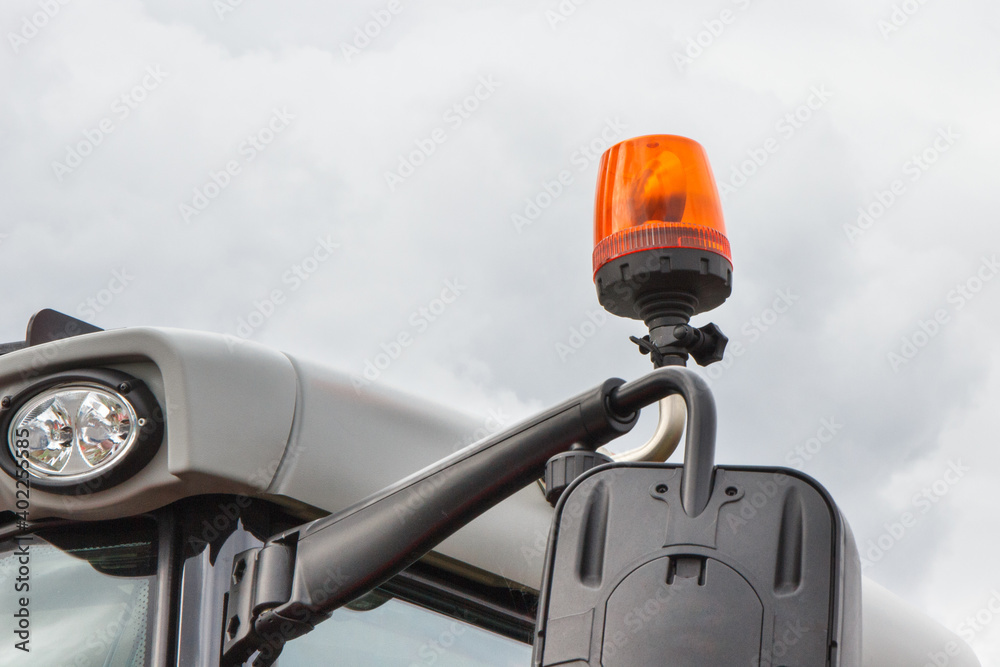 Fototapeta premium Orange signal lamp on forklift, excavator or other industrial machine. Safety during work
