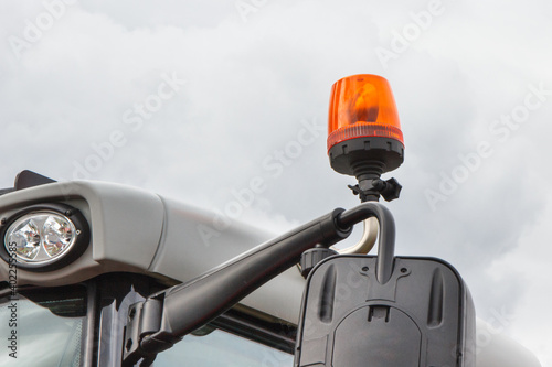 Orange signal lamp on forklift, excavator or other industrial machine. Safety during work