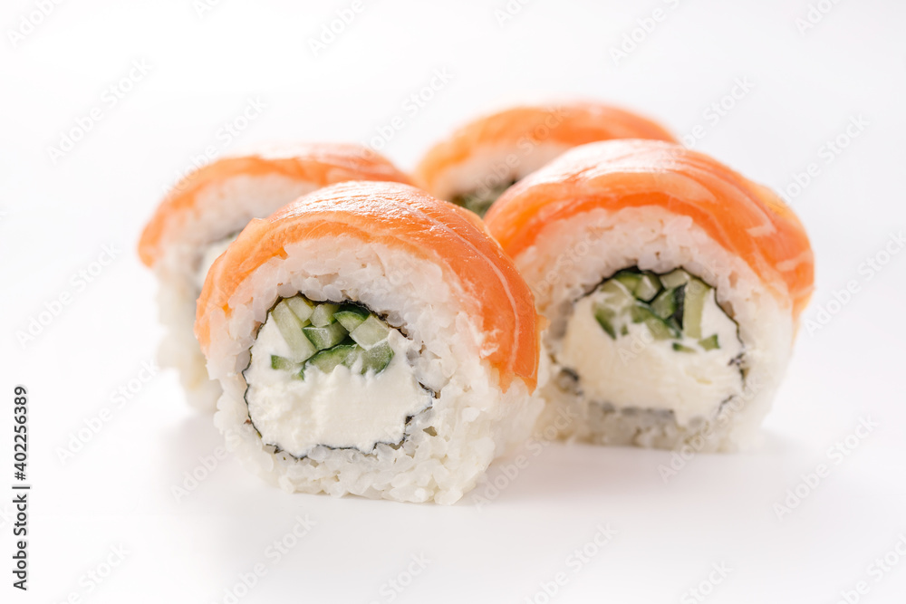 Philadelphia roll sushi on a white plate. Isolated. Restaurant concept. Close-up. Philadelphia roll sushi on a white plate. Isolated. Restaurant concept. Close-up.