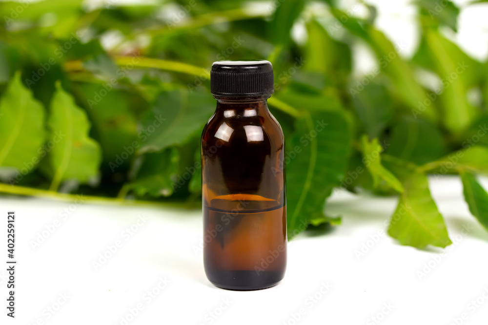 neem oil in bottle and neem leaf isolate on white background. neem oil in bottle and neem leaf isolate on white background.