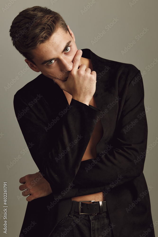 handsome man black shirt hand near face emotions self-confidence handsome man black shirt hand near face emotions self-confidence