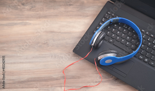 Blue headphones on the computer keyboard.