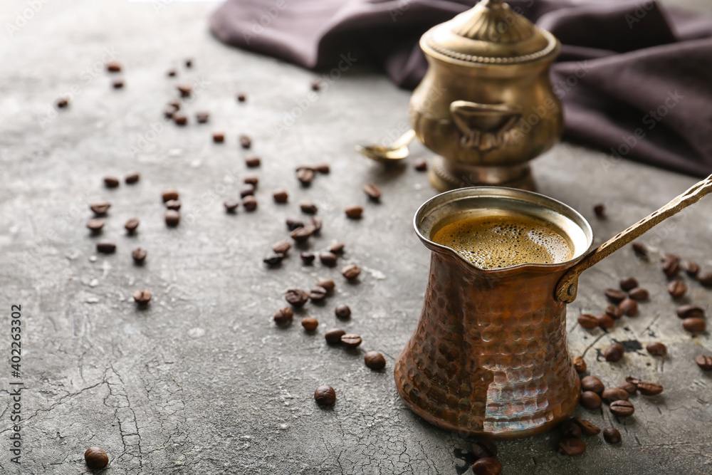 Turkish coffee in cezve on table Turkish coffee in cezve on table