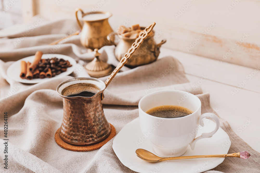Cezve, cup of coffee, sugar and milk on table Cezve, cup of coffee, sugar and milk on table