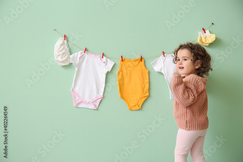 Cute baby girl near stylish...