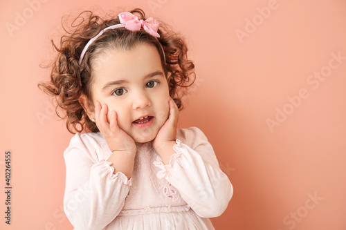 Cute baby girl on color bac...