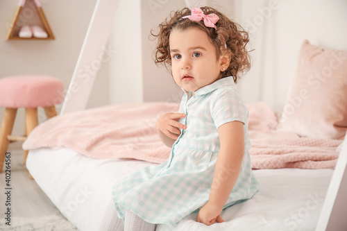 Cute baby girl in bedroom