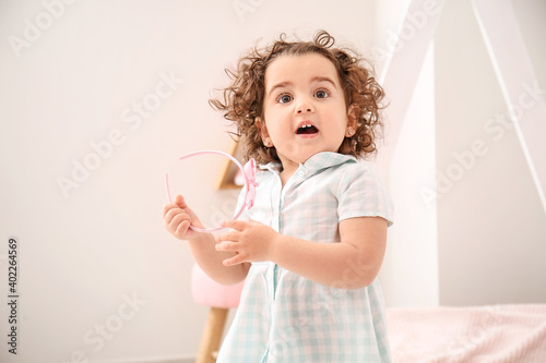 Surprised baby girl at home