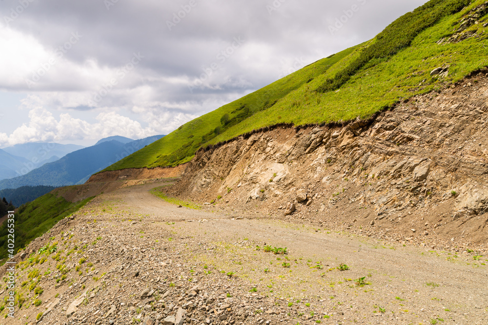 Curvy dirt road down a mountain side or slope