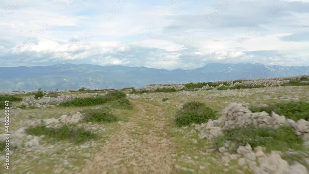 Low aerial flyover over the moon plateau on Krk Island, Croatia on a cloudy day Low aerial flyover over the moon plateau on Krk Island, Croatia on a cloudy day