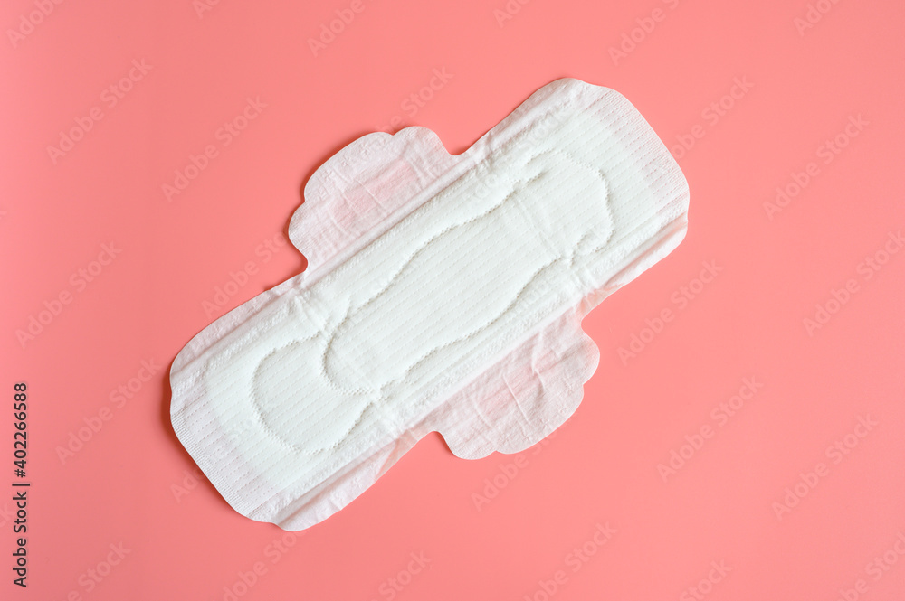 pure empty women's disposable menstrual sanitary pad or napkin for normal abundance of secretions on pink background pure empty women's disposable menstrual sanitary pad or napkin for normal abundance of secretions on pink background