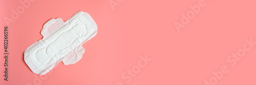 pure empty women's disposable menstrual sanitary pad or napkin for normal abundance of secretions on pink background. banner