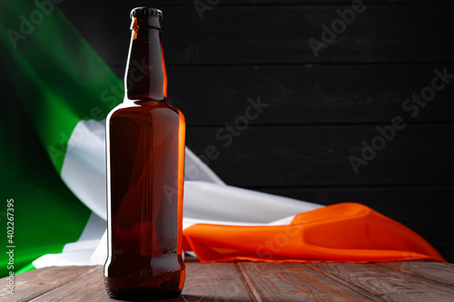 Fototapeta Bottle of beer against flag of Ireland