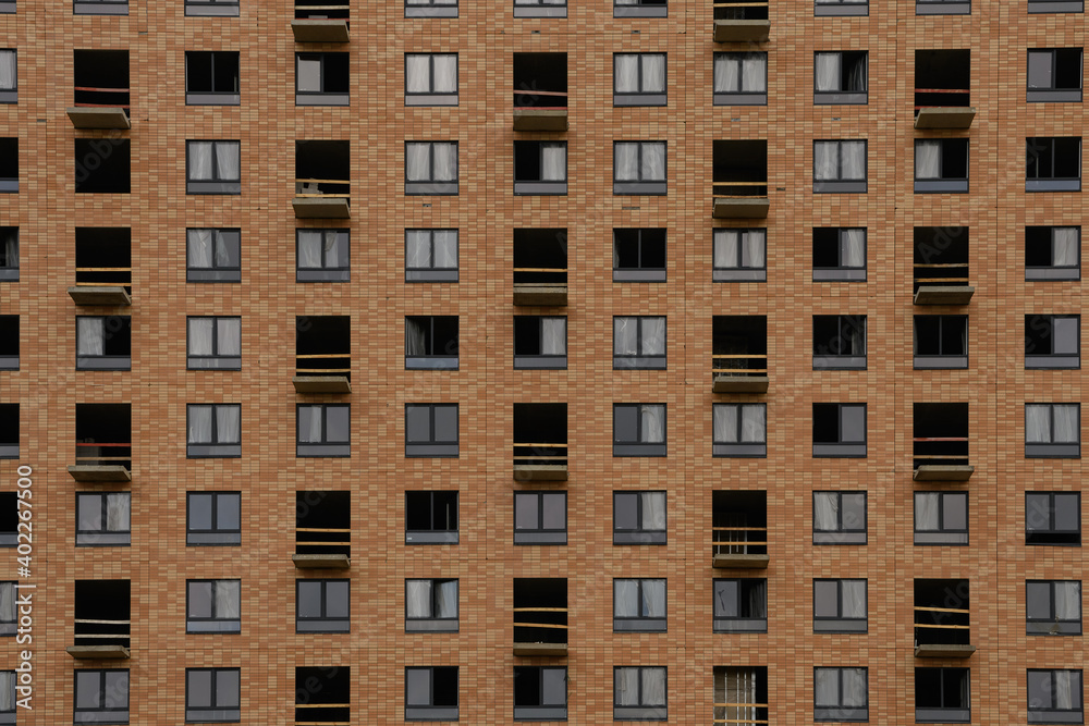 Facade with windows of an unfinished building, closeup house Facade with windows of an unfinished building, closeup house