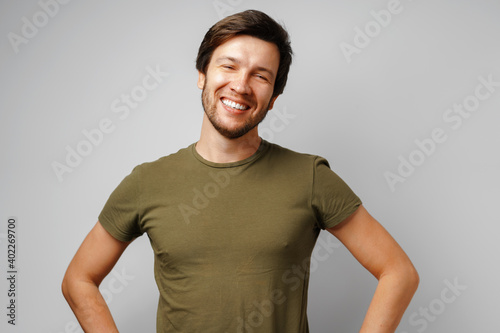 Handsome young man portrait smiling against grey background