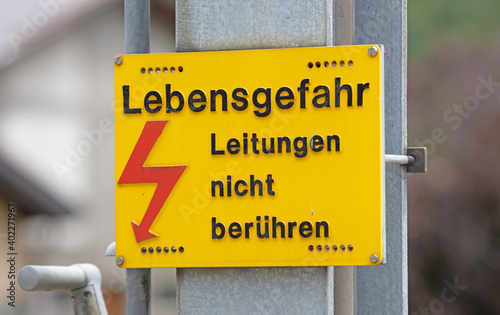 German warning sign `Don't touch high voltage power lines, danger to life` german: `Hochspannung, Leitungen nicht beruhren` photo