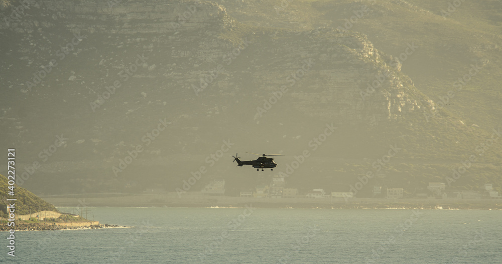 Fototapeta premium Helicopter over the sea during navy training exercises