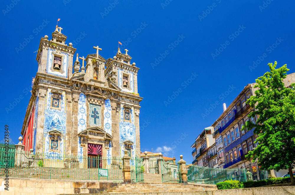 Saint Ildefonso Roman Catholic church in Batalha Square in Porto Oporto city historical centre, clear blue sky in sunny summer day background, Norte or Northern Portugal