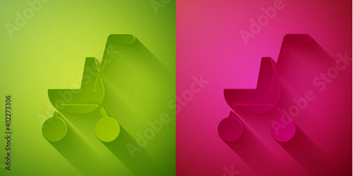 Paper cut Baby stroller icon isolated on green and pink background. Baby carriage, buggy, pram, stroller, wheel. Paper art style. Vector.
