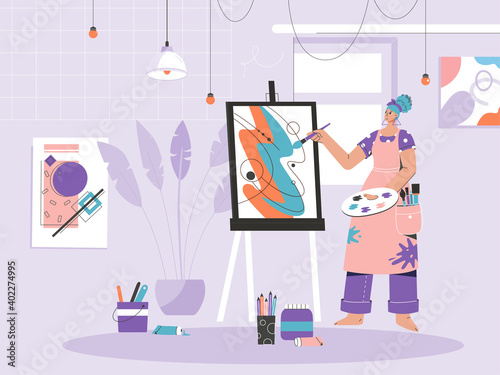 Woman painter drawing picture on canvas at easel