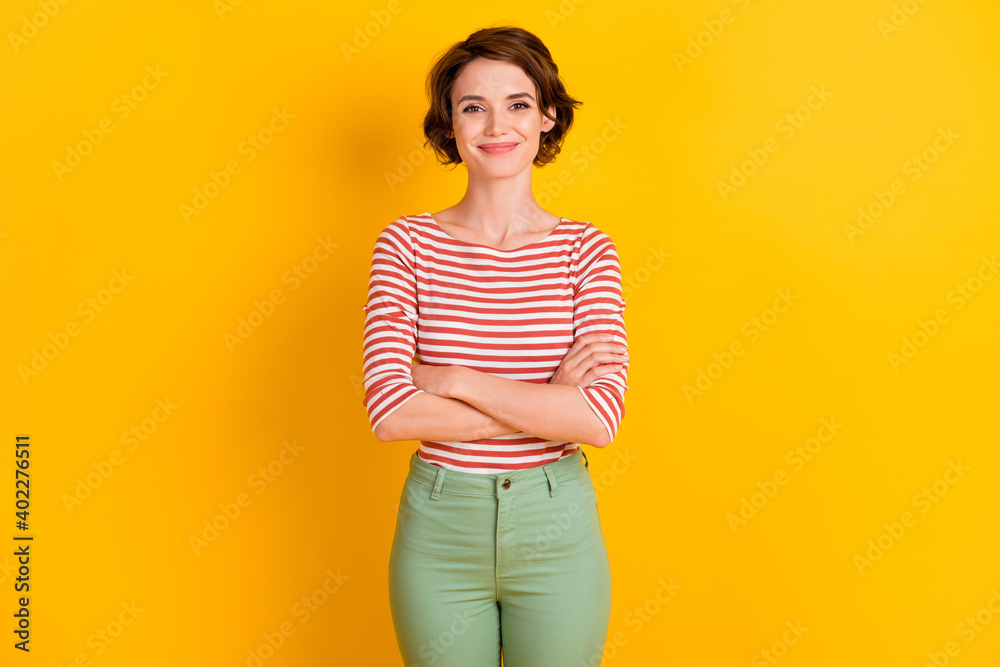 Photo of content positive person crossed arms look camera isolated on vibrant yellow color background