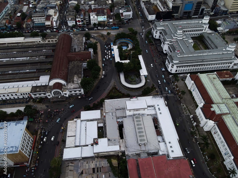 Aerial view of Jakarta Kota Train Station with Jakarta cityscape background. 