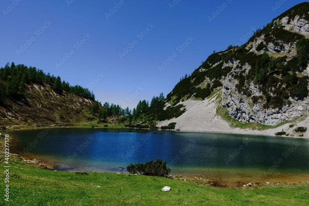 hiking in the summer in the mountains with a blue lake