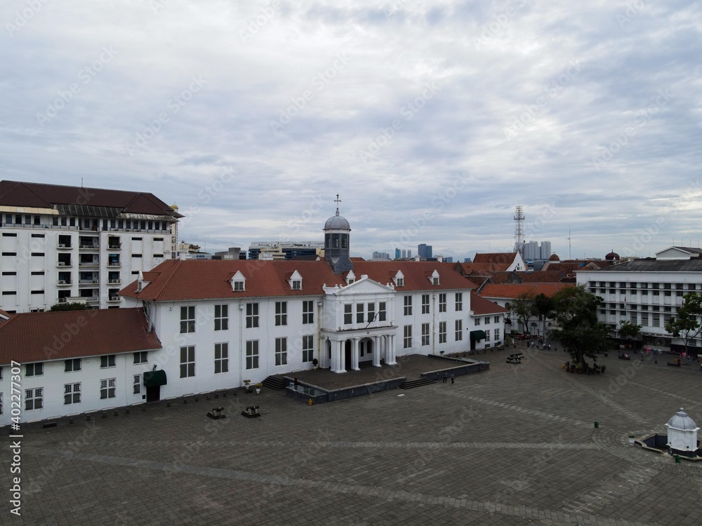 Aerial View. Fatahilah museum at Old City at Jakarta, Indonesia. With Jakarta cityscape and noise cloud when sunset