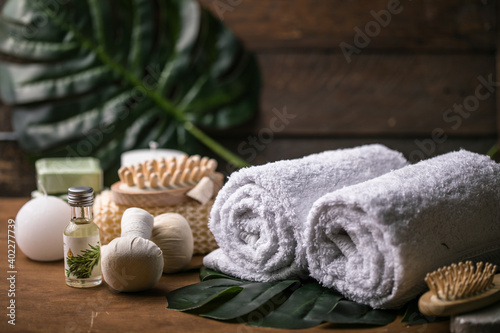 Wellness decoration, spa massage setting, oil on wooden background. Spa, Zen and relax concept. Spa treatment concept. Natural, Organic spa cosmetics products, sea salt, massage brush. Spa background