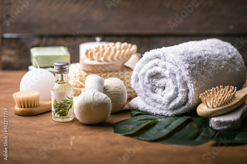 Wellness decoration, spa massage setting, oil on wooden background. Spa, Zen and relax concept. Spa treatment concept. Natural, Organic spa cosmetics products, sea salt, massage brush. Spa background