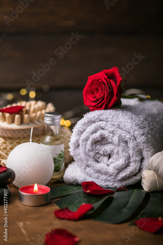 Wellness decoration, spa massage setting, oil on wooden background. Valentine's Day Zen and relax concept.