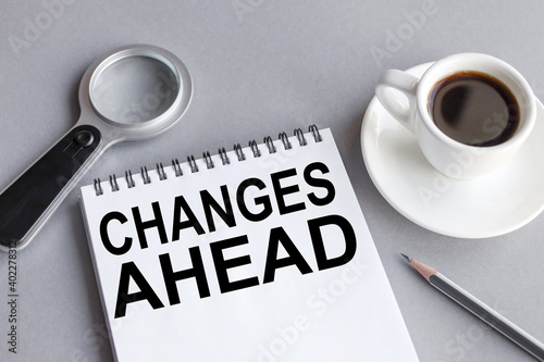 CHANGE AHEAD. TEXT or word on white paper on a gray background NEAR A CUP OF COFFEE