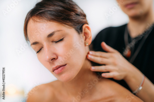 Ayurvedic Practitioner Massaging Female Client Neck with Ethereal Ayurveda Oil