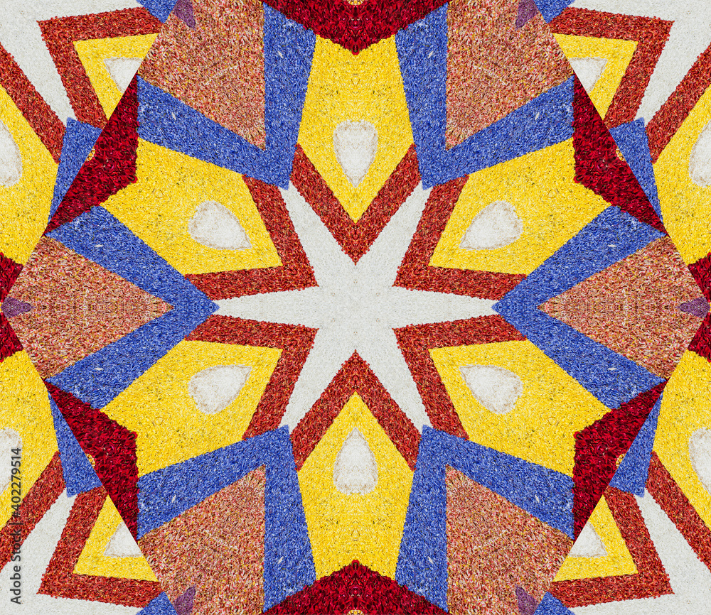 Abstract background with geometric kaleidoscopic design obtained from multicolored flower petals part of a large carpet at Corpus Christi celebration in La Orotava, Tenerife, Canary Islands, Spain Abstract background with geometric kaleidoscopic design obtained from multicolored flower petals part of a large carpet at Corpus Christi celebration in La Orotava, Tenerife, Canary Islands, Spain