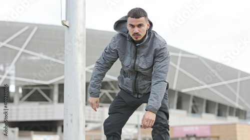 Wallpaper Mural Portrait Of Serious Young Man On The Street. Strict Guy On The Background Of The Building. He Stands And Then Squats. Torontodigital.ca