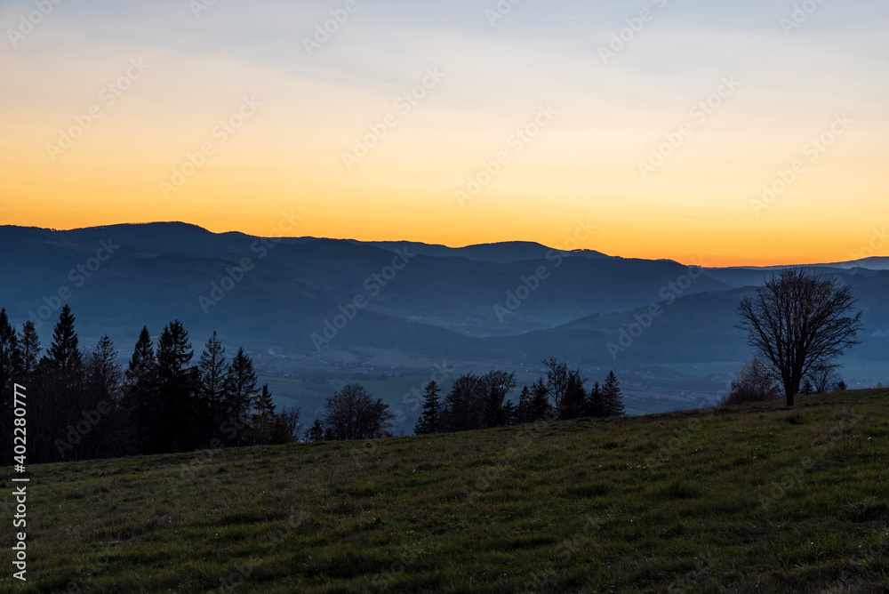Moravskoslezske Beskydy mountain rqange from Bahenec in Slezske Beskydy mountains in Czech republic after sunset