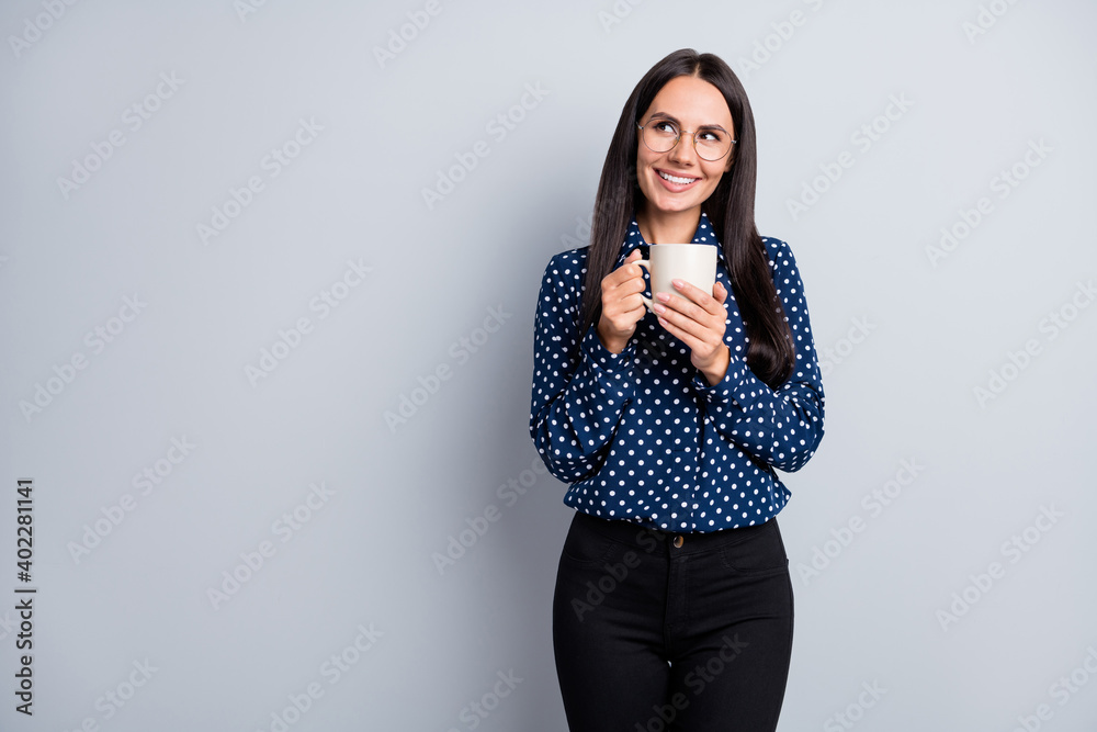 Photo of young beautiful charming pretty positive businesswoman in glasses dink tea isolated on grey color background Photo of young beautiful charming pretty positive businesswoman in glasses dink tea isolated on grey color background