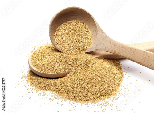 Amaranth seed pile in wooden spoon isolated on white background